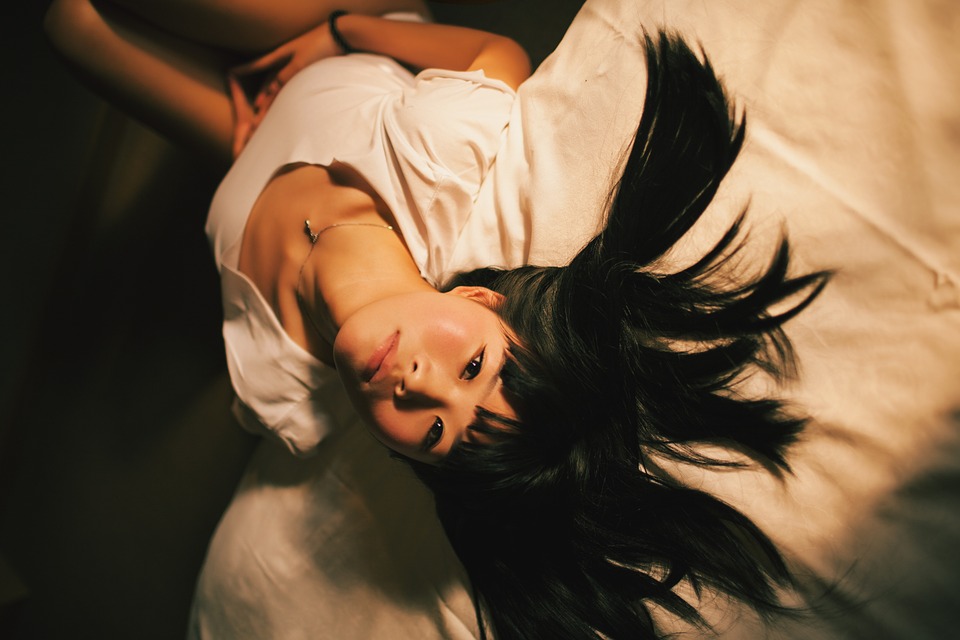 girl leaning on bed